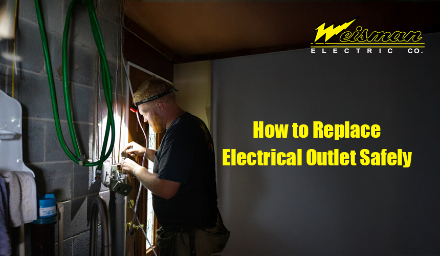 Electrician changing a wall outlet during home repair